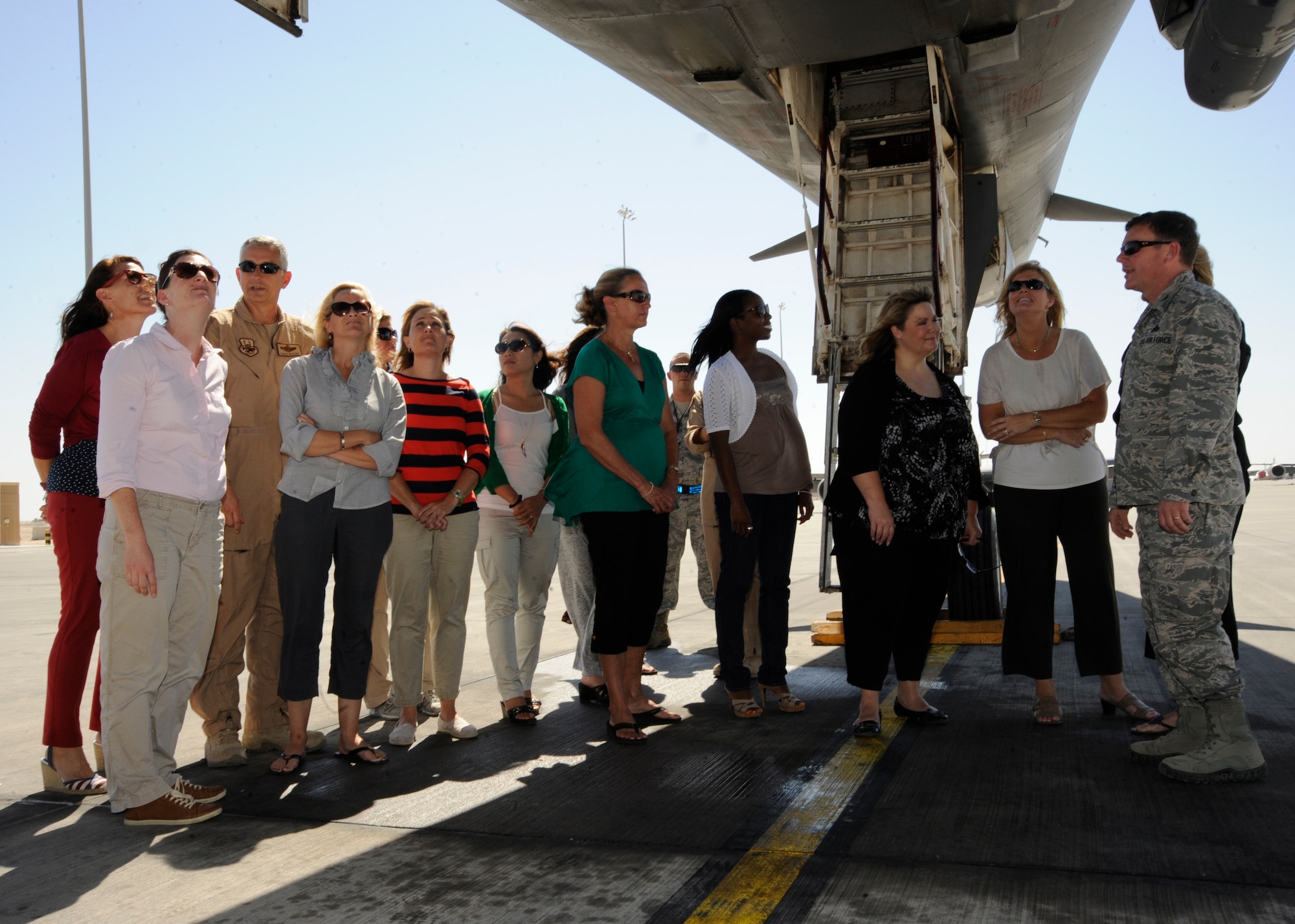 Col. Bryan Harris shows military spouses the bomb carriage on a B-1B Lancer during a Command Sponsorship Program tour at the 379th Air Expeditionary Wing in Southwest Asia, Oct. 23, 2013. The CSP leverages resources to improve support for families here and the tour familiarized families with the vast mission capabilities of the 379th AEW. Harris is the 379th Expeditionary Maintenance Group commander hereon a two-year controlled tour and a Marshall, Texas, native. (U.S. Air Force photo/Senior Airman Bahja J. Jones) 