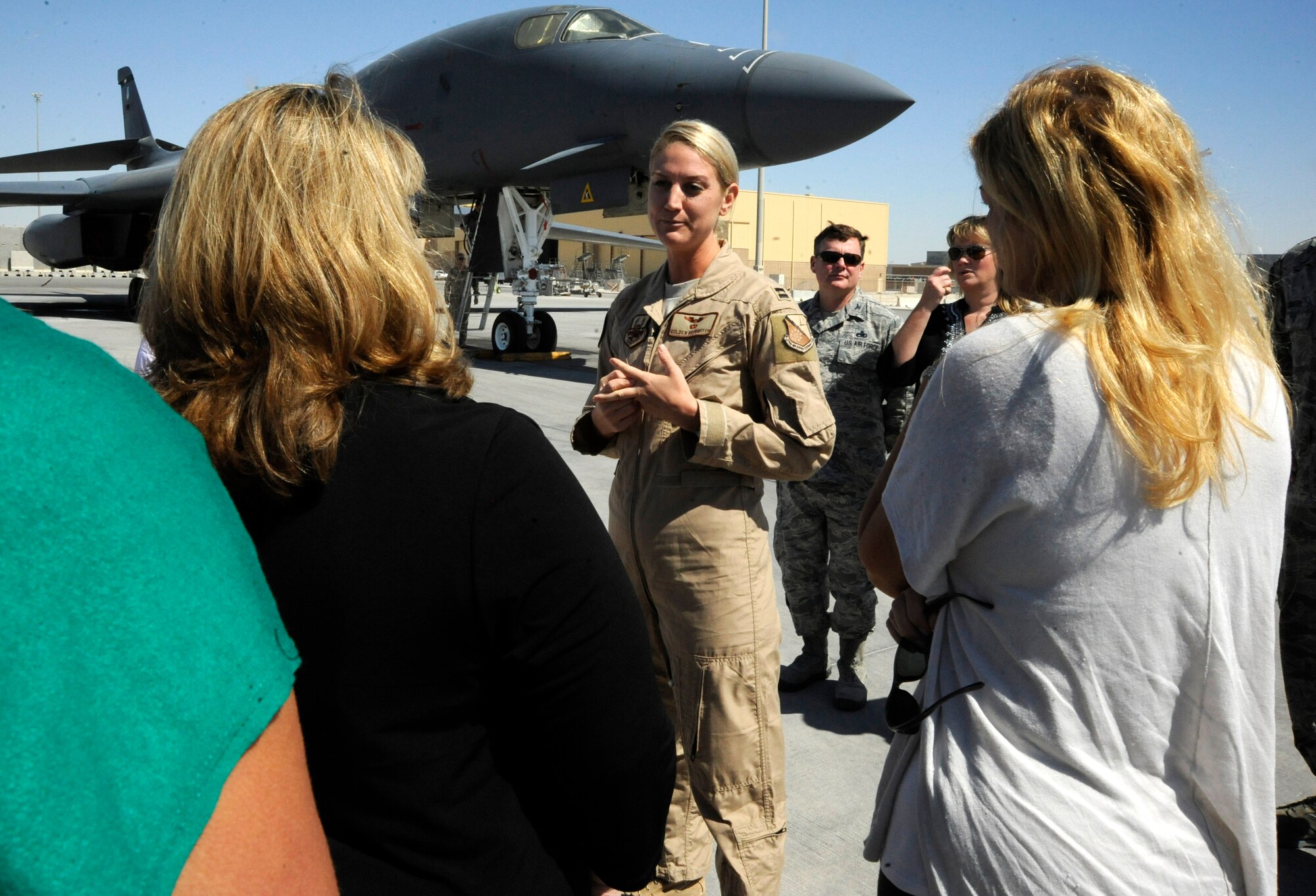 Capt. Golden Broughton gives military spouses a B-1B Lancer mission brief during a Command Sponsorship Program tour at the 379th Air Expeditionary Wing in Southwest Asia, Oct. 23, 2013. The CSP leverages resources to improve support for families here and the tour familiarized families with the vast mission capabilities of the 379th AEW. Broughton is a 9th Expeditionary Bomb Squadron B-1 weapon system officer deployed from Dyess Air Force Base, Texas, and a Portland, Ore., native. (U.S. Air Force photo/Senior Airman Bahja J. Jones) 