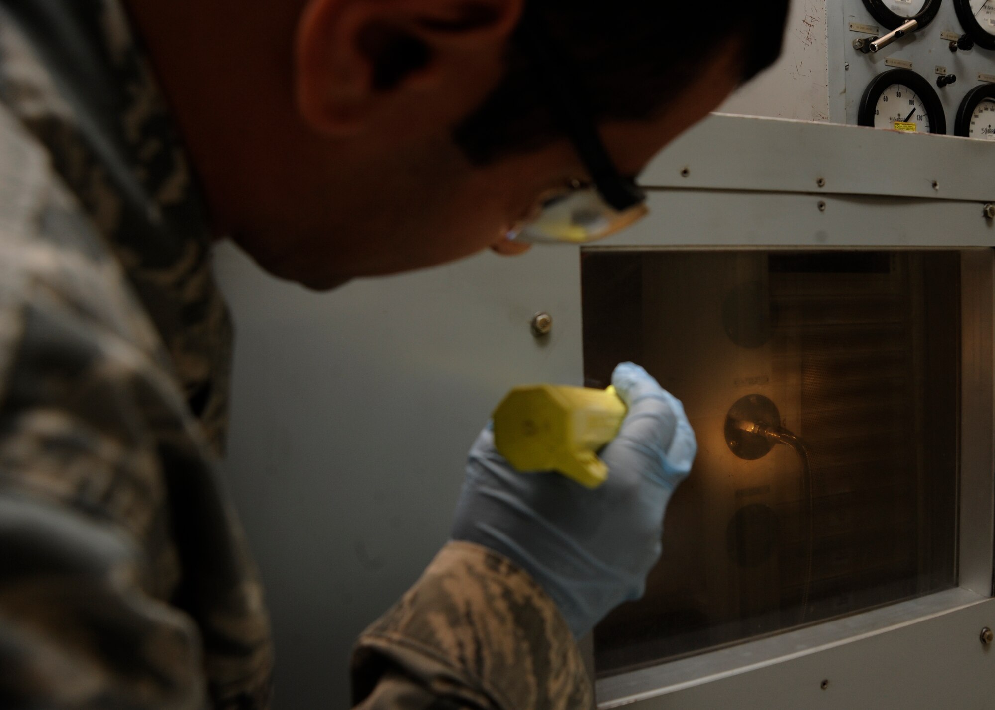 Tech. Sgt. Mohammed Abouhashem looks through a crash box on a hydraulic test stand to ensure there are no leaks from the hose at the 379th Air Expeditionary Wing in Southwest Asia, Oct. 15, 2013. The 379h Expeditionary Maintenance Squadron performs operations checks on a hydraulic test stand before returning the serviceable asset back to the supply system. Abouhashem is the 379th EMXS hydraulics section NCO in charge deployed from McConnell Air Force Base, Kan., and hails from Brooklyn, Ohio. (U.S. Air Force photo/Senior Airman Bahja J. Jones)


