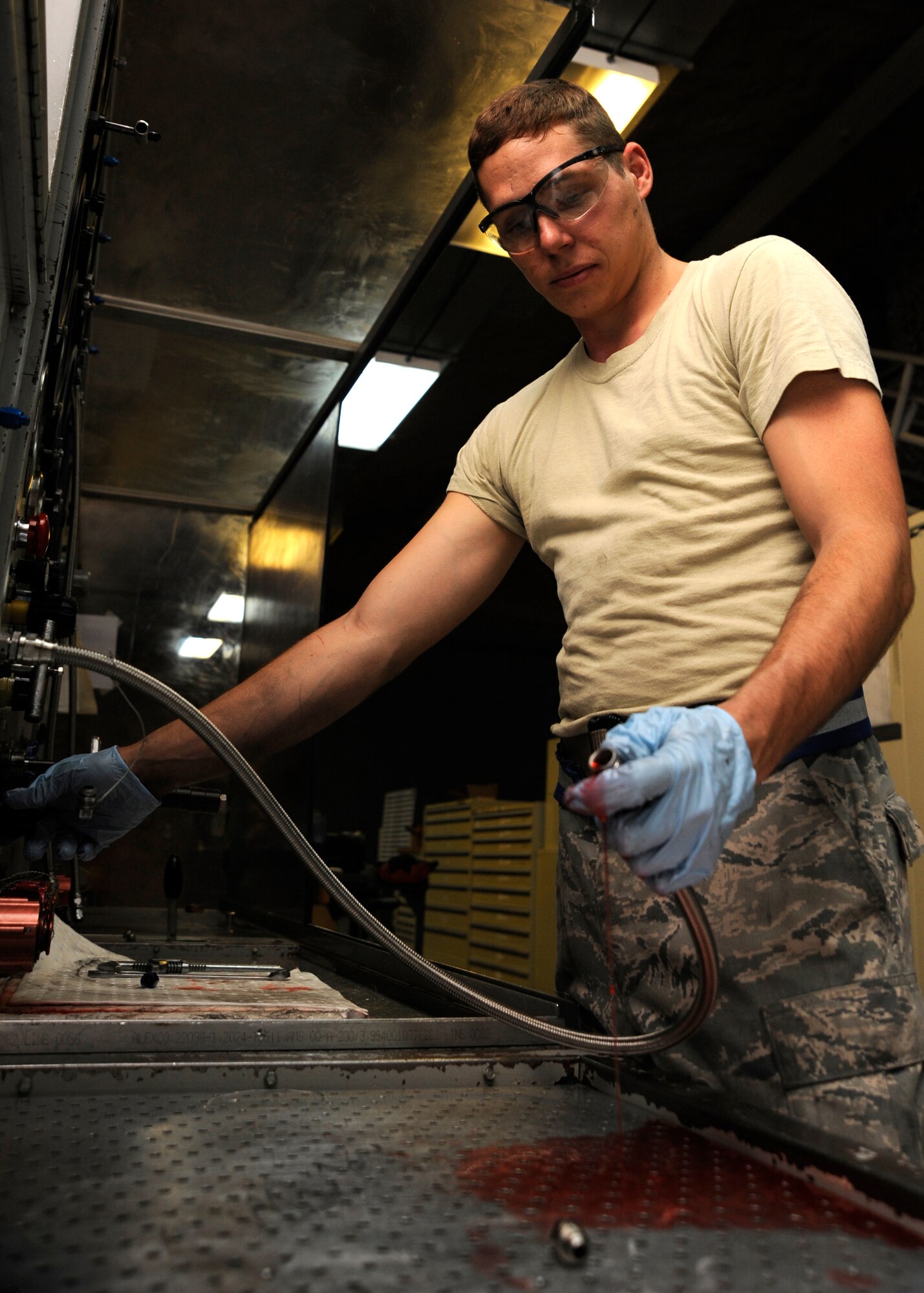 Senior Airman Wil Parker operates a hydraulic test stand to pressurize a hose at the 379th Air Expeditionary Wing in Southwest Asia, Oct. 15, 2013. Beyond support to KC-135 Stratotankers, the 379th Expeditionary Maintenance Squadron hydraulics section supports other weapon systems here by testing and fabricating hydraulic hoses. Parker is a 379th EMXS hydraulics section technician deployed from Kadena Air Base, Japan, and hails from Merritt Island, Fla. (U.S. Air Force photo/Senior Airman Bahja J. Jones) 