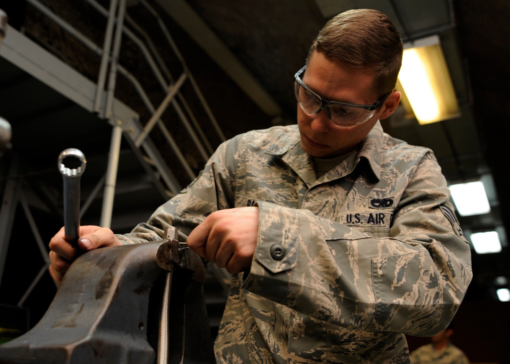 Senior Airman Wil Parker uses a vise to assemble a high-pressure Teflon hose at the 379th Air Expeditionary Wing in Southwest Asia, Oct. 15, 2013. Beyond support to KC-135 Stratotankers, the 379th Expeditionary Maintenance Squadron hydraulics section supports other weapon systems here by testing and fabricating hydraulic hoses. Parker is a 379th EMXS hydraulics section technician deployed from Kadena Air Base, Japan, and hails from Merritt Island, Fla. (U.S. Air Force photo/Senior Airman Bahja J. Jones) 