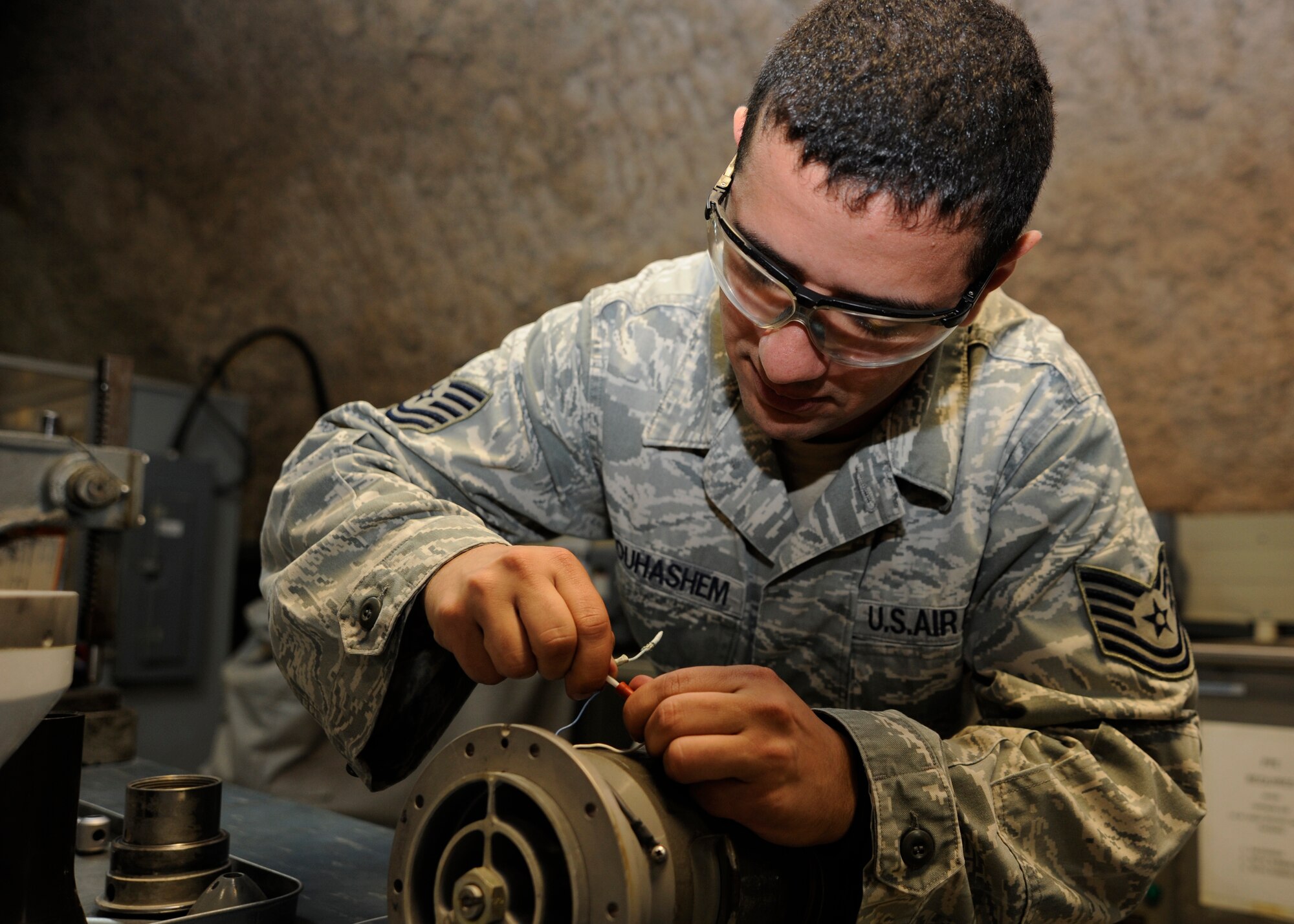 Tech. Sgt. Mohammed Abouhashem rewires a boom nozzle for a KC-135 Stratotanker at the 379th Air Expeditionary Wing in Southwest Asia, Oct. 15, 2013. The 379th Expeditionary Maintenance Squadron repair the aircraft’s hydraulic break assemblies, actuators, accumulators, boom nozzles, and drogue assemblies for KC-135s. Abouhashem is the 379th EMXS hydraulics section NCO in charge deployed from McConnell Air Force Base, Kan., and hails from Brooklyn, Ohio. (U.S. Air Force photo/Senior Airman Bahja J. Jones) 
