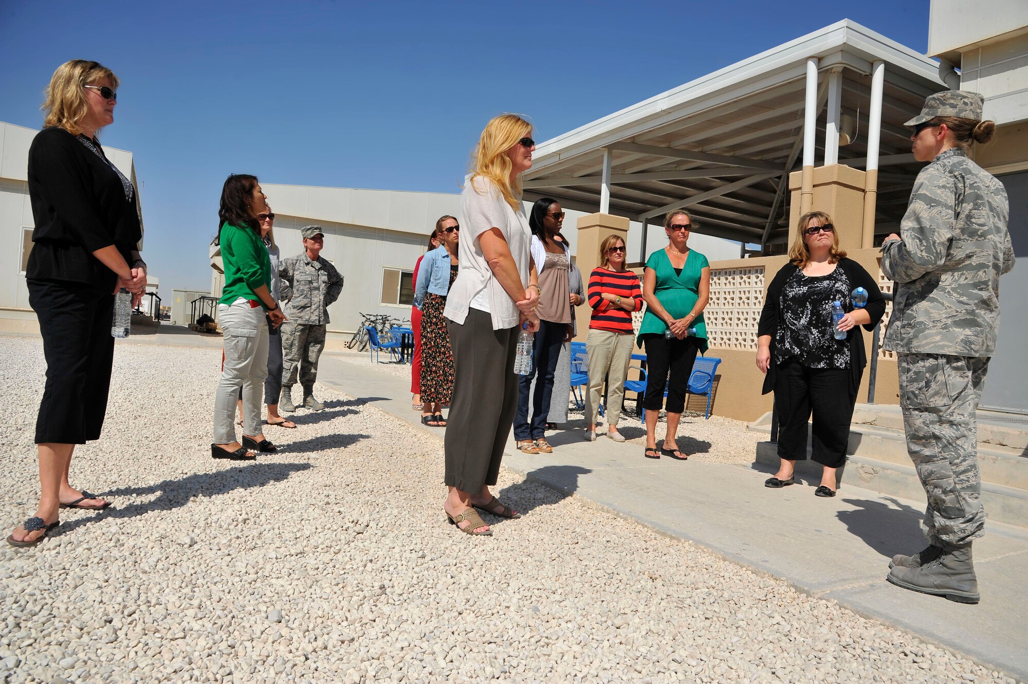 Lt. Col. Sirena Morris conducts a walking tour of facilities at memorial plaza to military spouses during a Command Sponsorship Program tour at the 379th Air Expeditionary Wing in Southwest Asia, Oct. 23, 2013. The CSP is an accompanied-tour initiative started in 2011 to increase mission effectiveness through extended permanent party presence, greater mission continuity and fewer burdens on families.  Morris is the 379th Expeditionary Force Support Squadron commander here on a one-year controlled tour and hails from Fayetteville, N.C. (U.S. Air Force photo/Tech. Sgt. Joselito Aribuabo)