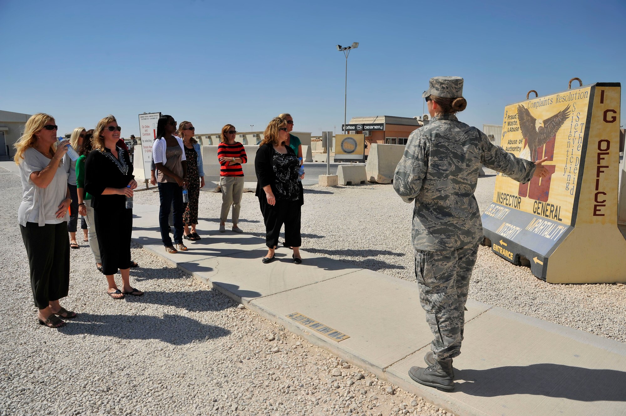 Lt. Col. Sirena Morris conducts a walking tour of facilities at memorial plaza to military spouses during a Command Sponsorship Program tour at the 379th Air Expeditionary Wing in Southwest Asia, Oct. 23, 2013. The CSP is an accompanied-tour initiative started in 2011 to increase mission effectiveness through extended permanent party presence, greater mission continuity and fewer burdens on families.  Morris is the 379th Expeditionary Force Support Squadron commander here on a one-year controlled tour and hails from Fayetteville, N.C. (U.S. Air Force photo/Tech. Sgt. Joselito Aribuabo)