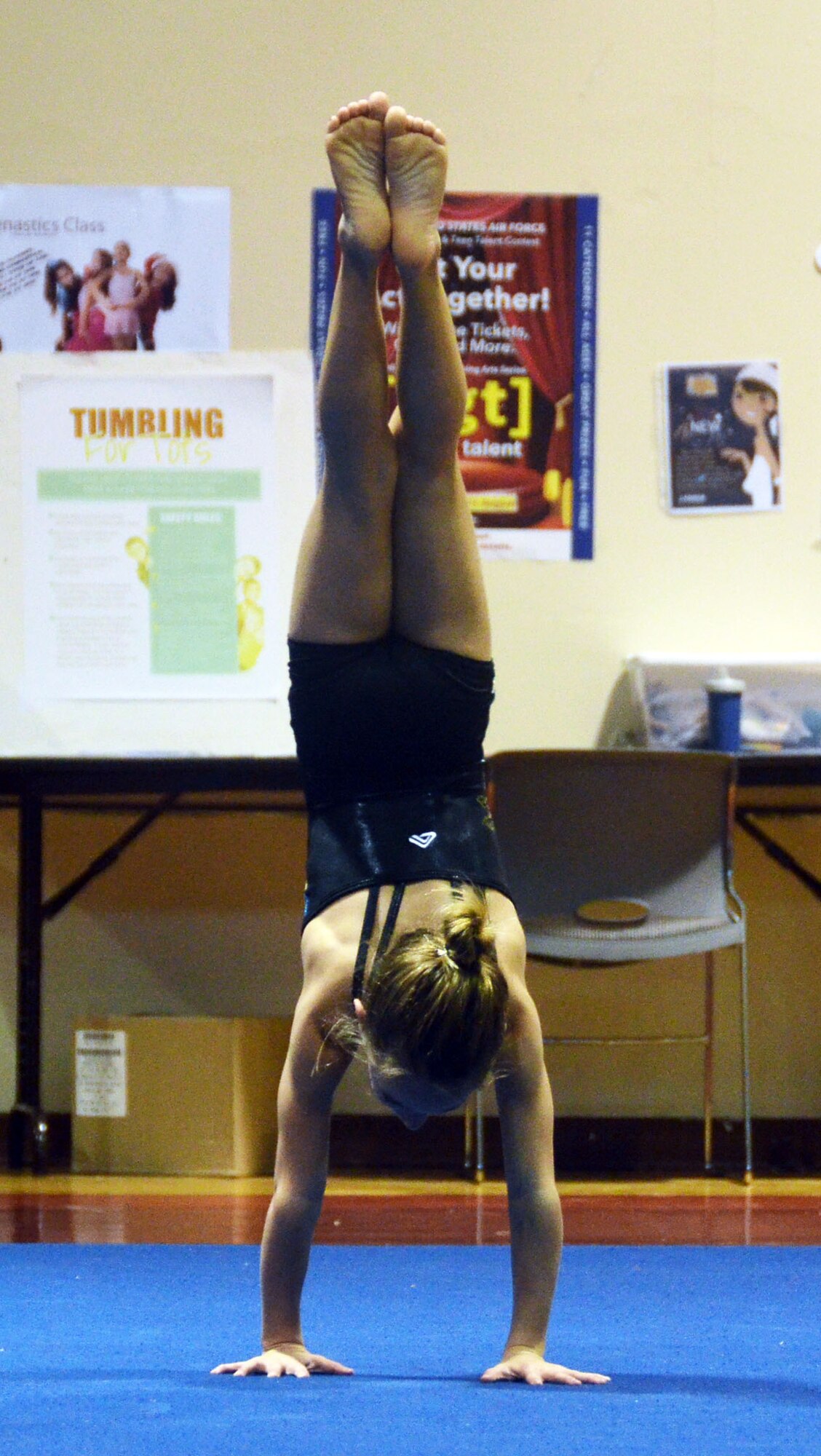 Hannah Cavazos performs a hand stand during her gymnastics routine that won her second place at the annual “U Got Talent” show Oct. 23, 2013, at the Hot Spot on Andersen Air Force Base, Guam. The talent show is conducted Air Force-wide and video of each installation’s first and second place winners are then sent to the Air Force Entertainment Office for Air Force-level judging. (U.S. Air Force photo by Airman 1st Class Mariah Haddenham/Released)