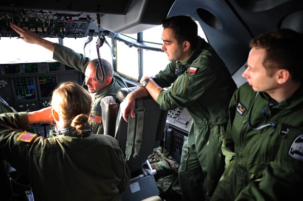Pilots from the Polish air force and Airmen from the 37th Airlift Squadron go through a pre-flight brief during a theater security cooperation event, Oct. 21, 2013, Powidz Air Transport Base, Poland. Airmen from Ramstein Air Base, Germany got a unique opportunity to work hand-in-hand with their Polish counterparts. (U.S. Air Force photo/Senior Airman Hailey Haux)