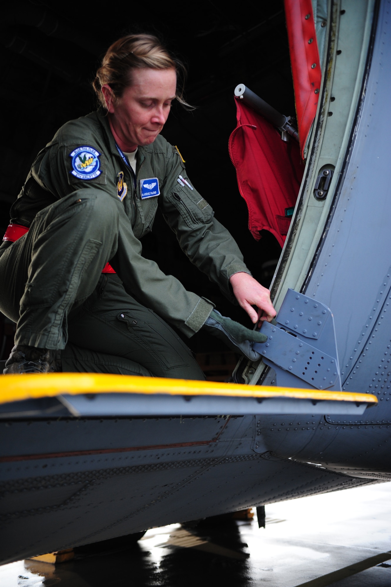 Senior Airman Jodi Parks, 37th Airlift Squadron loadmaster, checks the side door of a C-130J Super Hurcules before takeoff during a theater security cooperation event, Oct. 21, 2013, Powidz Air Transport Base, Poland. Loadmasters have a checklist of items to run through prior to departure to ensure the aircraft is fully functional. (U.S. Air Force photo/Senior Airman Hailey Haux)