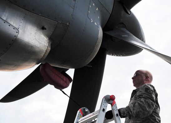 Tech. Sgt. Brian Craner, 86th Aircraft Maintenance Squadron crew chief, removes pads from the propeller of a C-130J Super Hercules during a theater security cooperation event, Oct. 21, 2013, Powidz Air Transport Base, Poland. Airmen from the 86th AMXS travel with the aircraft to ensure it stays maintained and mission ready. (U.S. Air Force photo/Senior Airman Hailey Haux)