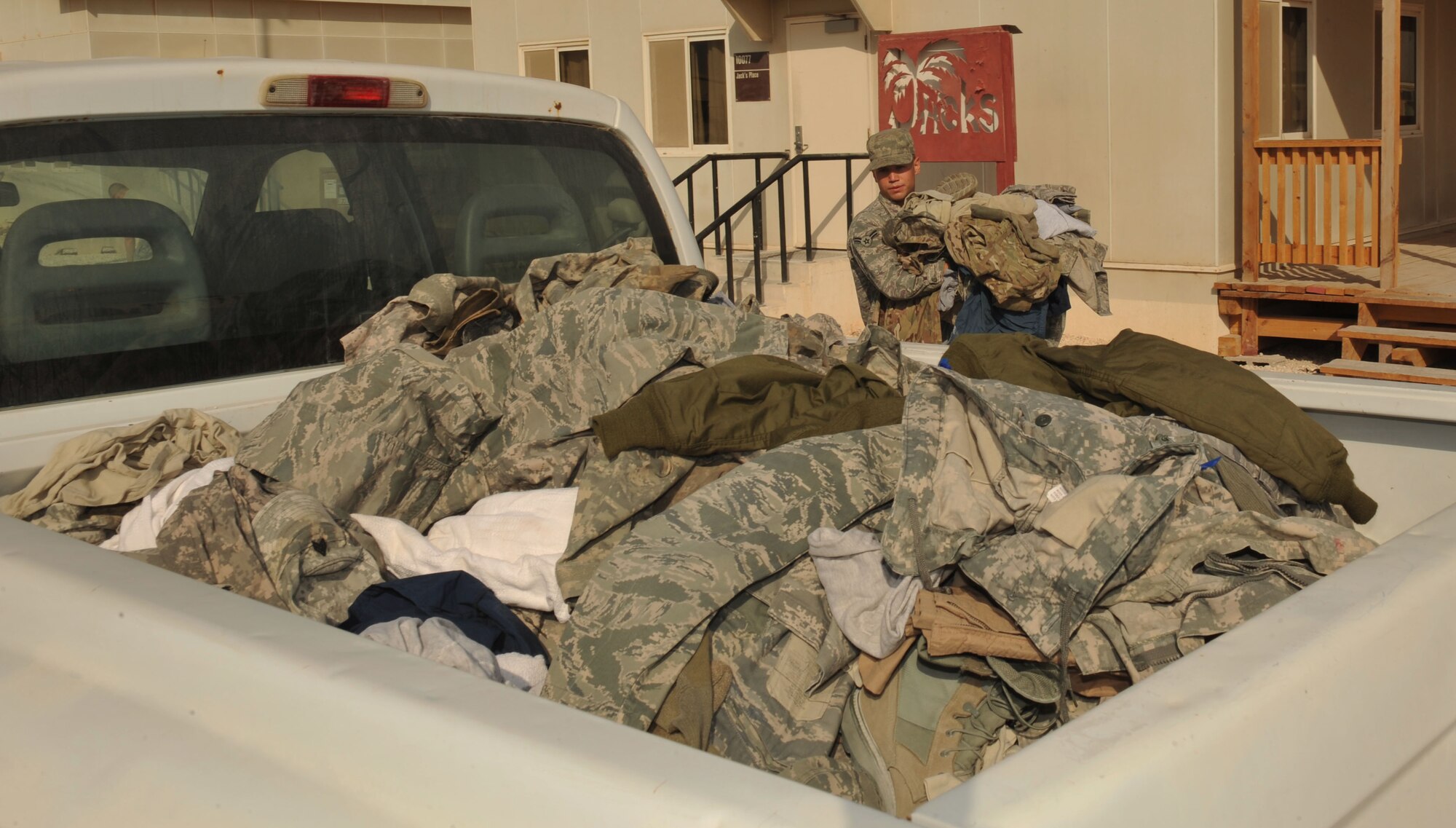 Airman 1st Class Ryan Peterson volunteers to collect uniform items at one of 15 uniform drop boxes at the 379th Air Expeditionary Wing in Southwest Asia, Oct. 15, 2013. Uniform drop boxes are placed around base to ensure members do not throw uniform items in dumpsters as this could cause degraded force protection and operations security efforts. Peterson is a 379th Expeditionary Civil Engineer Squadron heating, ventilation, air conditioning, and refrigeration apprentice deployed from Joint Base Langley-Eustis, Va., and a Minneapolis native. (U.S. Air Force photo/Master Sgt. David Miller)
