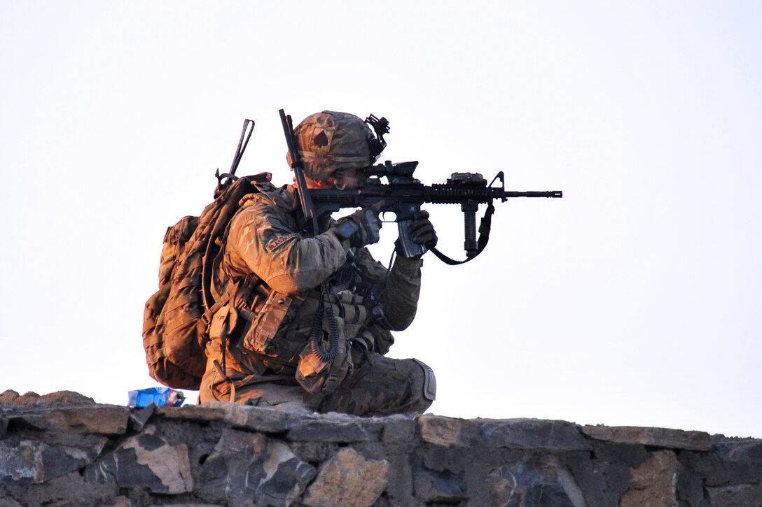 U.S. Army Staff Sgt. Eric Blaszkowski uses his weapon’s optic lens to scan the surrounding area from a roof top position during a partnered patrol in Madi Khel village in Khowst province, Afghanistan, Oct. 20, 2013. Blaszkowski, a forward observer, is assigned to the 101st Airborne Division's Company E, 2nd Battalion, 506th Infantry Regiment, 4th Brigade Combat Team.