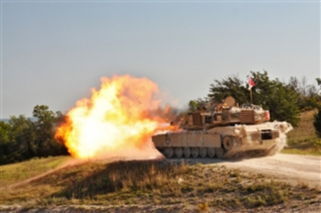 U.S. Army soldiers fire the 120mm main gun of an Army M1A2 Abrams tank during live-fire gunnery training at Fort Hood, Texas, on Sept. 24, 2013.   The soldiers are assigned to the 3rd Battalion, 8th Cavalry Regiment, 3rd Brigade Combat Team, 1st Cavalry Division.  