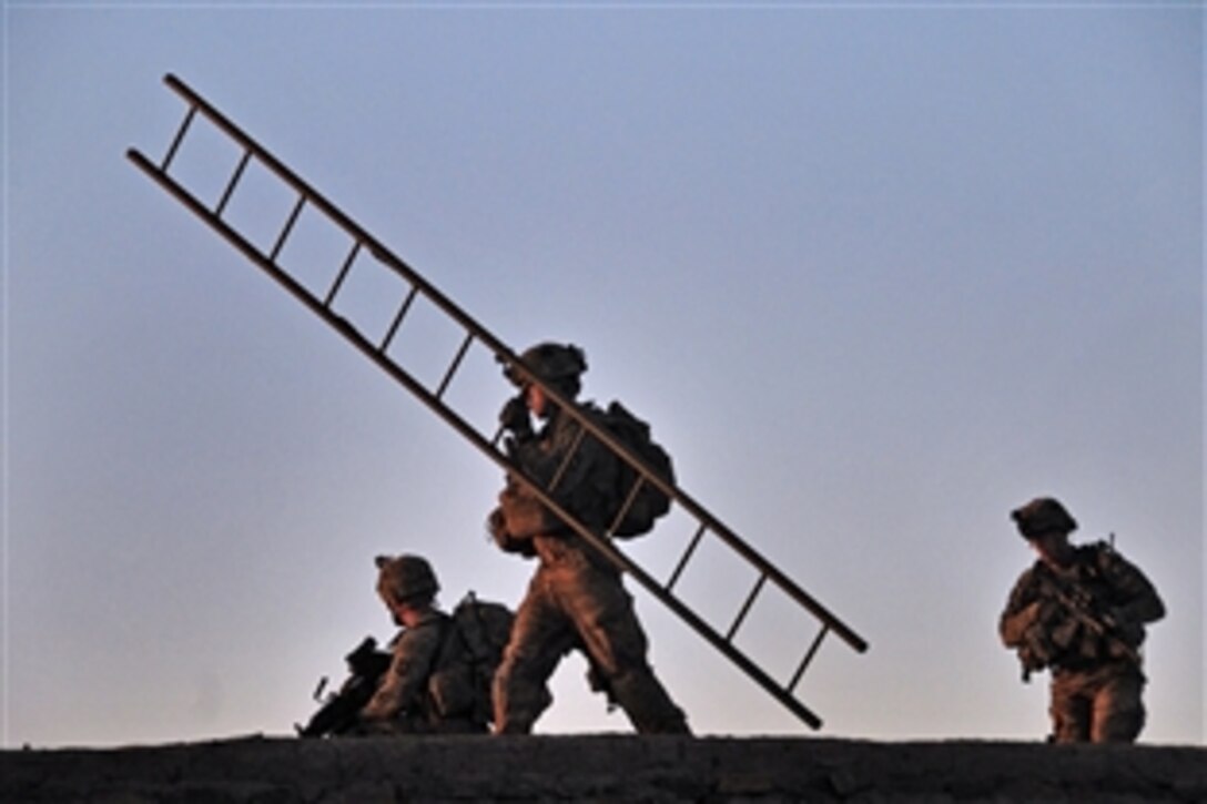 U.S. soldiers traverse a roof top observation position during a partnered patrol in Madi Khel, Khowst province, Afghanistan, Oct. 20, 2013. The soldiers, assigned to 101st Airborne Division's Company E, 2nd Battalion, 506th Infantry Regiment, 4th Brigade Combat Team "Currahee", conducted a partnered operation with the newly formed Khowst Provincial Response Company.