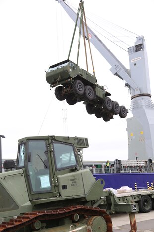 A crane lifts a Logistics Vehicle System Replacement Cargo Vehicle (LVSR) into the air to load onto a cargo ship bound for Tinian for Exercise Forager Fury II, at the Marine Corps Air Station Iwakuni, Japan, harbor, Oct. 23, 2013. The vessel is a ‘lift on lift off’ ship, meaning a crane must lift each piece of equipment on and off the ship.