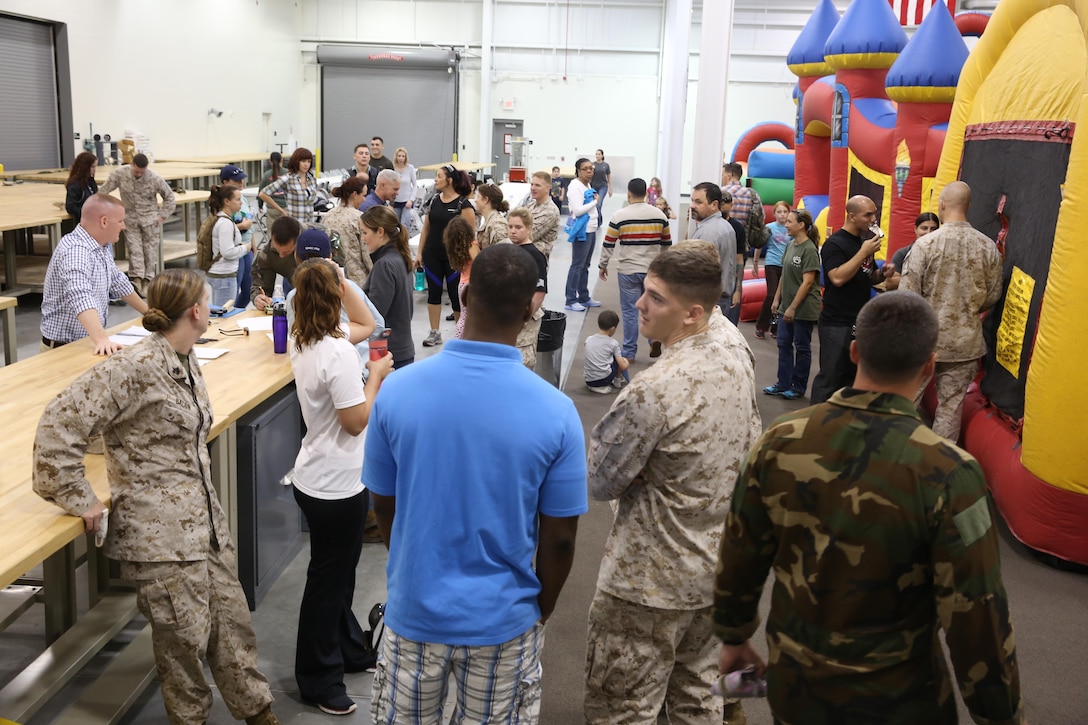 Marine Special Operations Regiment hosted a Jane Wayne Day event, Oct 19, 2013, on Camp Lejeune, N.C.  Wives of U.S. Marine Corps Forces, Special Operations Command personnel participated in the event, experiencing firsthand how Marines with MARSOC train for missions. This Jane Wayne Day event immersed participants in an interactive scenario comprising patrols, a run through an obstacle course, rides on zodiac boats, encounters with role-players and a simulated raid on a town.  MARSOC Marines supervised the entire event, and assisted the family members throughout the scenario. (U.S. Marine Corps Photo by Lance Cpl. Steven Fox/Released)