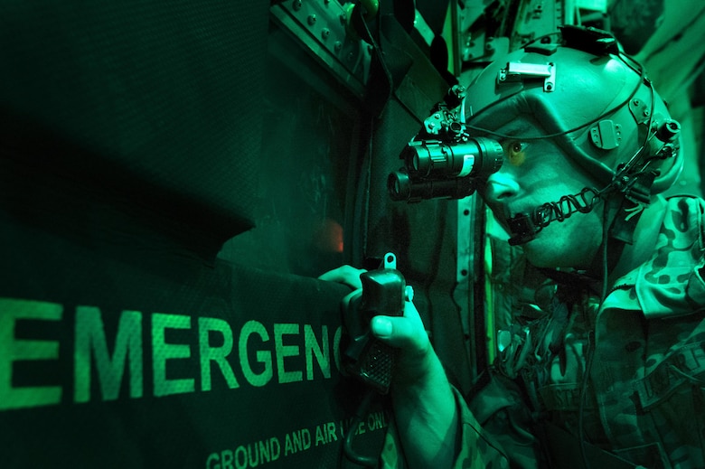 Senior Airman Larry Webster scans for potential threats using night vision goggles after completing a cargo airdrop Oct. 7, 2013, in Ghazni Province, Afghanistan. Webster is a 774th Expeditionary Airlift Squadron loadmaster. (U.S. Air Force photo/Master Sgt. Ben Bloker)