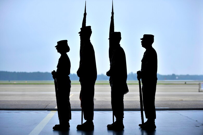 Members of the Shaw Air Force Base Honor Guard stand at attention in preparation to present the colors during a retirement ceremony Oct. 18, 2013, at Shaw AFB, S.C. Shaw's honor guard pride themselves on working together as a cohesive unit while performing their duties at each ceremony they attend. (U.S. Air Force photo/Airman 1st Class Jensen Stidham)