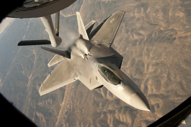 An F-22 Raptor backs away from a KC-135 Stratotanker during a training mission over central New Mexico Oct. 23, 2013. The Raptor is assigned to the 49th Fighter Wing, at Holloman Air Force Base, N.M. The KC-135 is from McConnell Air Force Base, Kan. (U.S. Air Force photo/Airman 1st Class John Linzmeier)