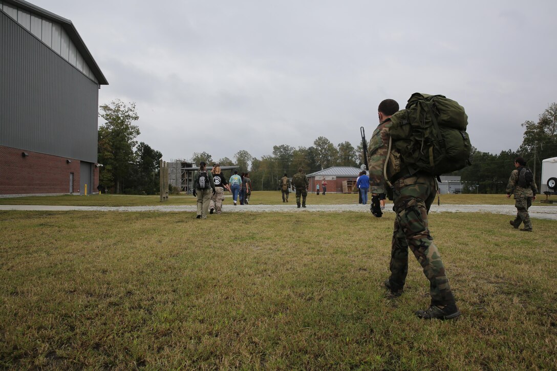 Marine Special Operations Regiment hosted a Jane Wayne Day event, Oct. 19, 2013, on Camp Lejeune, N.C.  Wives of U.S. Marine Corps Forces, Special Operations Command personnel participated in the event, experiencing firsthand how Marines with MARSOC train for missions. This Jane Wayne Day event immersed participants in an interactive scenario comprising patrols, a run through an obstacle course, rides on zodiac boats, encounters with role-players and a simulated raid on a town.  MARSOC Marines supervised the entire event, and assisted the family members throughout the scenario. (U.S. Marine Corps Photo by Lance Cpl. Steven Fox/Released)