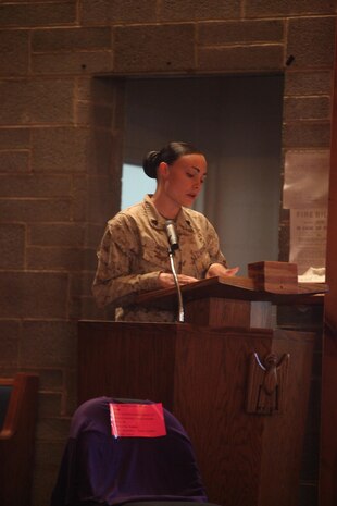 Sgt. Amanda King, a survivor of domestic violence, shares her story of survival during a candlelight vigil held to remember the victims of domestic violence and raise awreness at the Marine Corps Air Station New River chapel, Oct. 17.