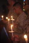 Marines hold candles to honor the victims of domestic violence, Oct. 17. The Marine Corps Air Station New River chapel put on this event to raise awareness for victims of domestic violence in North Carolina.