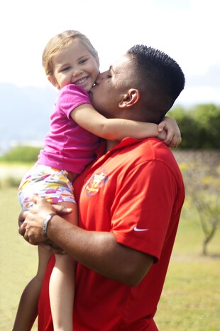 Sgt. Rafael Cervantes Jr., a Marine with Wounded Warrior Battalion West-Detachment Hawaii recovering from injuries sustained from an improvised explosive device blast, holds his four-year-old daughter Sophia at the Marine Corps Base Hawaii Iwo Jima Memorial, Oct. 23. (U.S. Marine Corps photo by Lance Cpl. Suzanna Knotts)