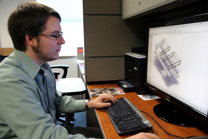 Dave McCarthy, an engineer developmental program employee at Marine Corps Systems Command, views a drawing on a 3-D solid modeling, computer-aided drawing and simulation basic simulations only software package. McCarthy came to work for MCSC through the Naval Acquisition Development program.