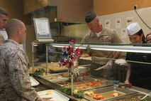 Col. Timothy M. Salmon, Marine Corps Air Station New River station commanding officer, serves food at the mess hall aboard the air station to commemorate the Navy's 238th birthday Oct. 11.