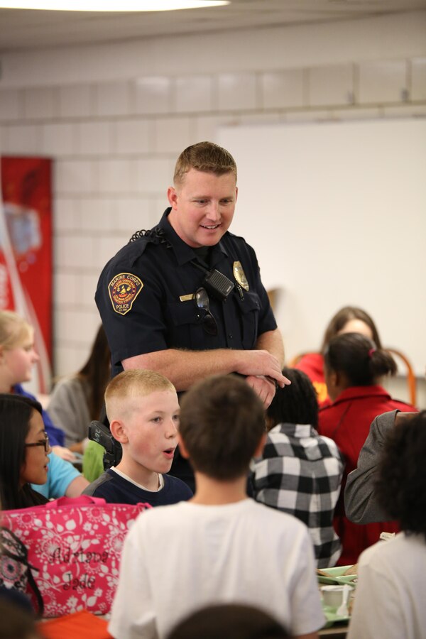 Christopher Dorsett, Quantico Middle/High School resource officer, talks with students during their lunch period on Oct. 24, 2013. Dorsett has been providing security for the school since August.