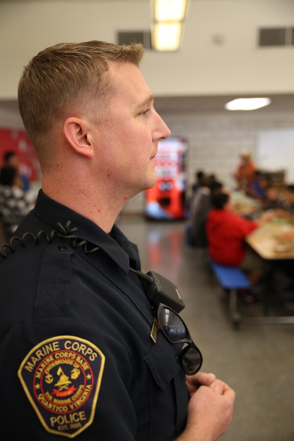 Christopher Dorsett, Quantico Middle/High School resource officer, watches over students during their lunch period on Oct. 24, 2013. Dorsett has been providing security for the school since August.