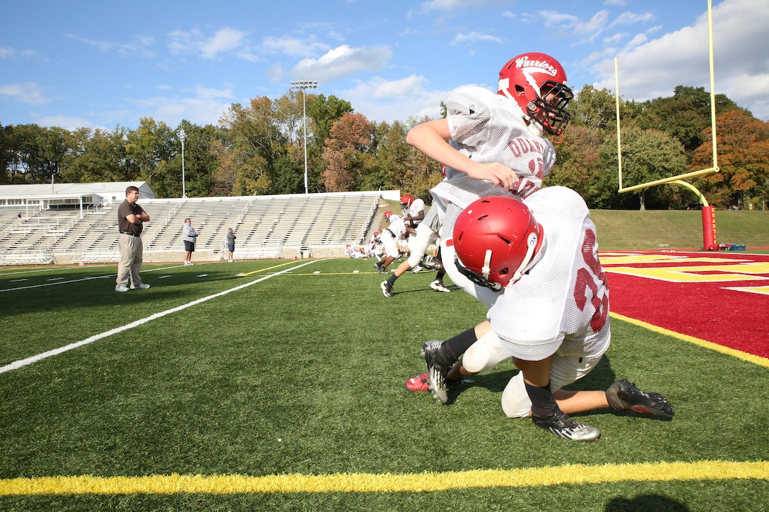 The Quantico Warriors practice football drills aboard Marine Corps Base Quantico on Oct. 24, 2013. The Warriors beat the Rappahannock County High School Panthers on Oct. 18, securing the highest scoring season since 2010.