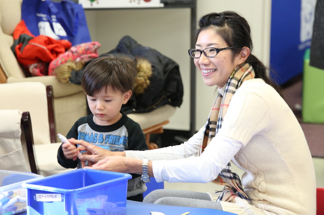 Harumi Allen and her son Taiyo, 2, color a craft during an event hosted by the New Parent Support Program at Little Hall on Oct. 25, 2013. The event was themed after the children’s book, “The Very Hungry Caterpillar” and provided many resources to assist parents with their children’s nutrition.