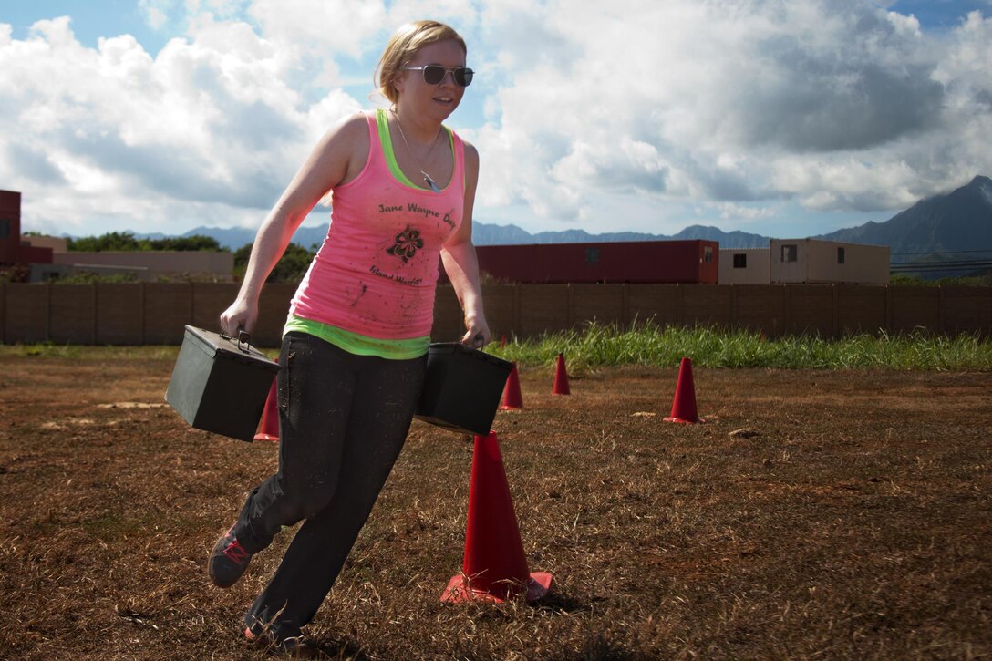 Lesley Floyd, wife of a Marine, runs with ammo cans through the Combat Fitness Test portion of Jane Wayne Day at Boondocker Training Area, Oct. 18, 2013. (Official U.S. Marine Corps photo by Lance Cpl. Nathan Knapke) 