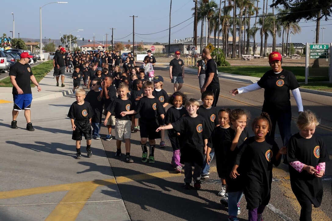Children from the Youth and Teen Center walk to raise drug awareness during Red Ribbon Week aboard Marine Corps Air Station Miramar, Calif., Oct. 24.  The children walked approximately a mile around the air station before returning to the Youth and Teen Center.