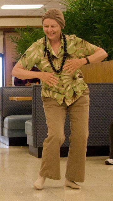 Diane Drigot, former senior natural resources management specialist with the Environmental Compliance and Protection Department, dances hula at Anderson Hall Dining Facility April 16, 2010. (U.S. Marine Corps photo by Kristen Wong)