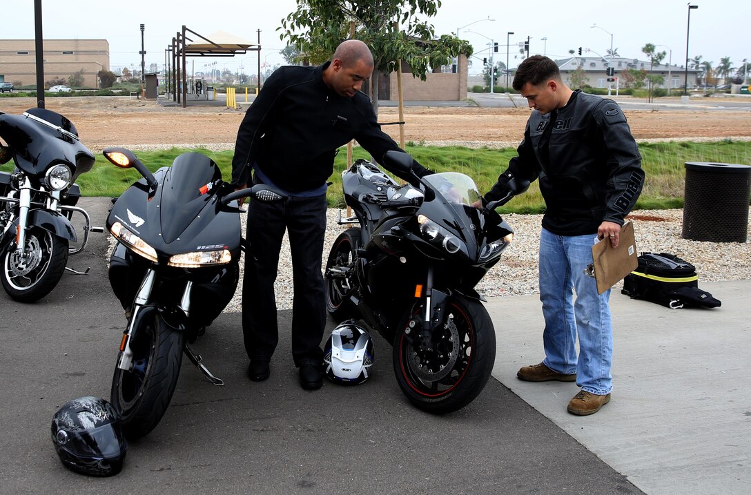 Lance Cpl. William Dickens, right, a Sylvester, W.Va., native, and Gunnery Sgt. Michael Thomas, left, a Jacksonville, Fla., native, both Headquarters and Headquarters Squadron motorcycle club members, inspect Dickens’ bike before going on a squadron motorcycle ride aboard Marine Corps Air Station Miramar, Calif., Oct. 25. Riders and their peers checked one another’s bikes to ensure their equipment was safe for their journey.