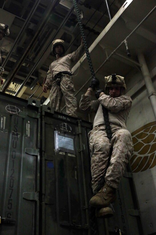 U.S. Marines with Battalion Landing Team 1/4,13th Marine Expeditionary Unit participate in fast rope training in the hangar bay aboard USS New Orleans (LPD 18) Oct. 21, 2013. The 13th MEU is deployed with the Boxer Amphibious Ready Group as a theater reserve and crisis response force throughout the U.S. 5th Fleet area of responsibility. (U.S. Marine Corps photo by Cpl. David Gonzalez, 13th Marine Expeditionary Unit Combat Camera/Released)