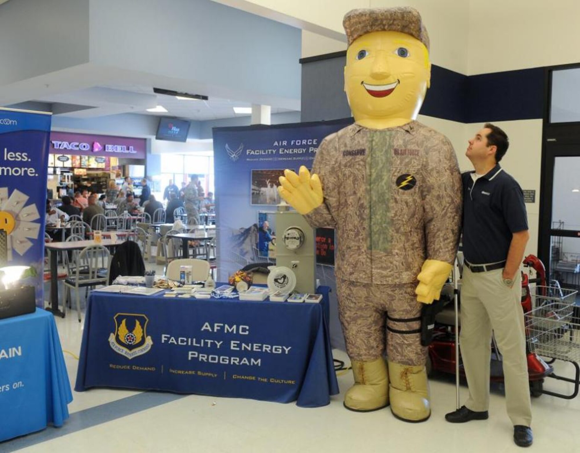 Daryn Tufts, who is "Therm" from Questar, looks up to another energy conservation mascot Col. Conserve (Senior Airman Travis Patt, 649th Munitions Squadron) at the Energy Fair held Oct. 9 at the Base Exchange Food Court. Both mascots stand tall. Therm is 6 foot 6 inches and Col. Conserve is close to 8 feet tall. (U.S. Air Force photo by Alex R. Lloyd/Released)