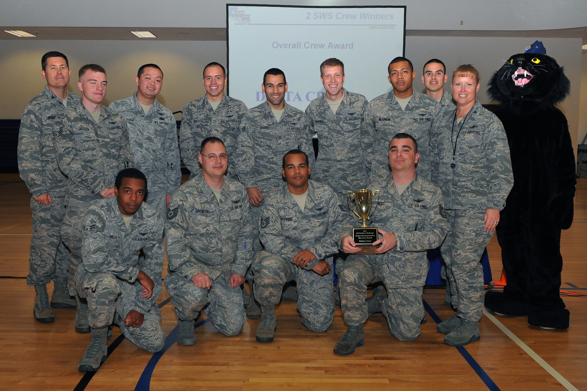 Members of the 2nd Space Warning Squadron delta crew receive the award for best crew during the Panther Challenge award ceremony Oct. 25, 2013, at the fitness center on Buckley Air Force Base, Colo. The Panther Challenge was the first competition to be held in honor of the Guardian Challenge used to test different groups within the 460th OG. (U.S. Air Force photo by Senior Airman Phillip Houk/Released)