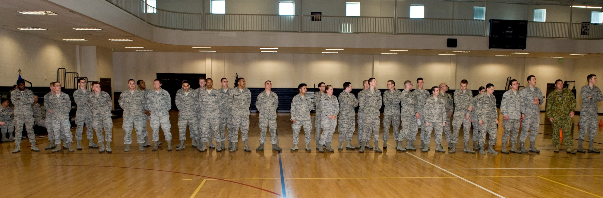 Members of the 460th Operations Group prepare for the announcement of the Panther Challenge winners Oct. 25, 2013, at the fitness center on Buckley Air Force Base, Colo. The Panther Challenge was the first competition to be held in honor of the Guardian Challenge used to test different groups within the 460th OG. (U.S. Air Force photo by Senior Airman Phillip Houk/Released)