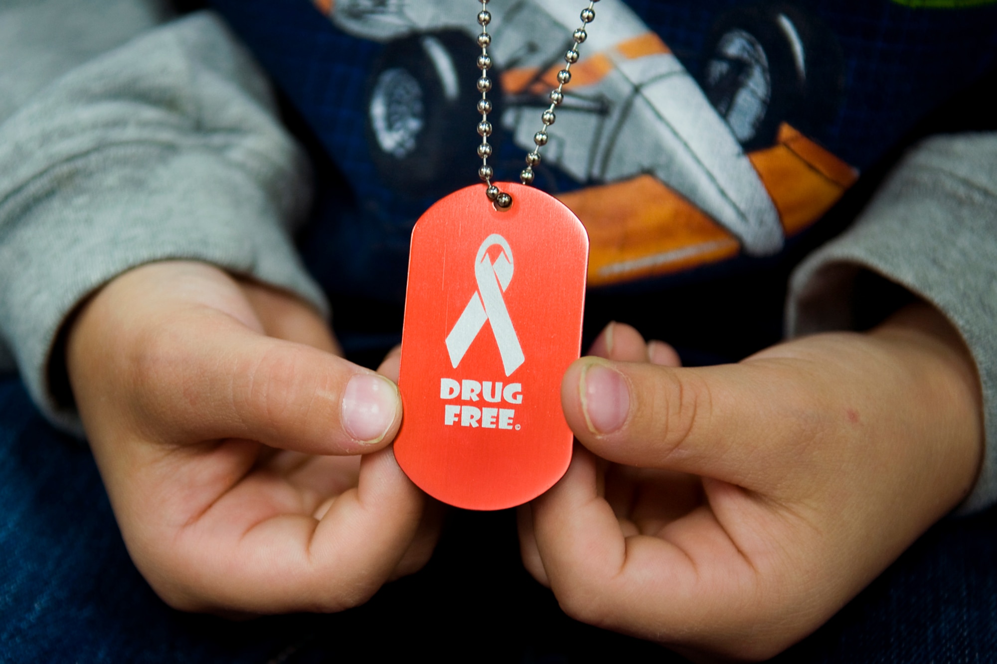 A kindergarten student from Pipe Creek Elementary in Peru, Ind., admires a "Drug Free" dog tag given to him by 434th Air Refueling Wing Airmen  as they taught local area children about the dangers of drug and alcohol abuse Oct. 22-25. This year the Airmen from Grissom Air Reserve Base, Ind., visited Pipe Creek Elementary in Peru, Ind., and North Miami Elementary in Denver, Ind. (U.S. Air Force photo/Tech. Sgt. Mark R. W. Orders-Woempner) 
