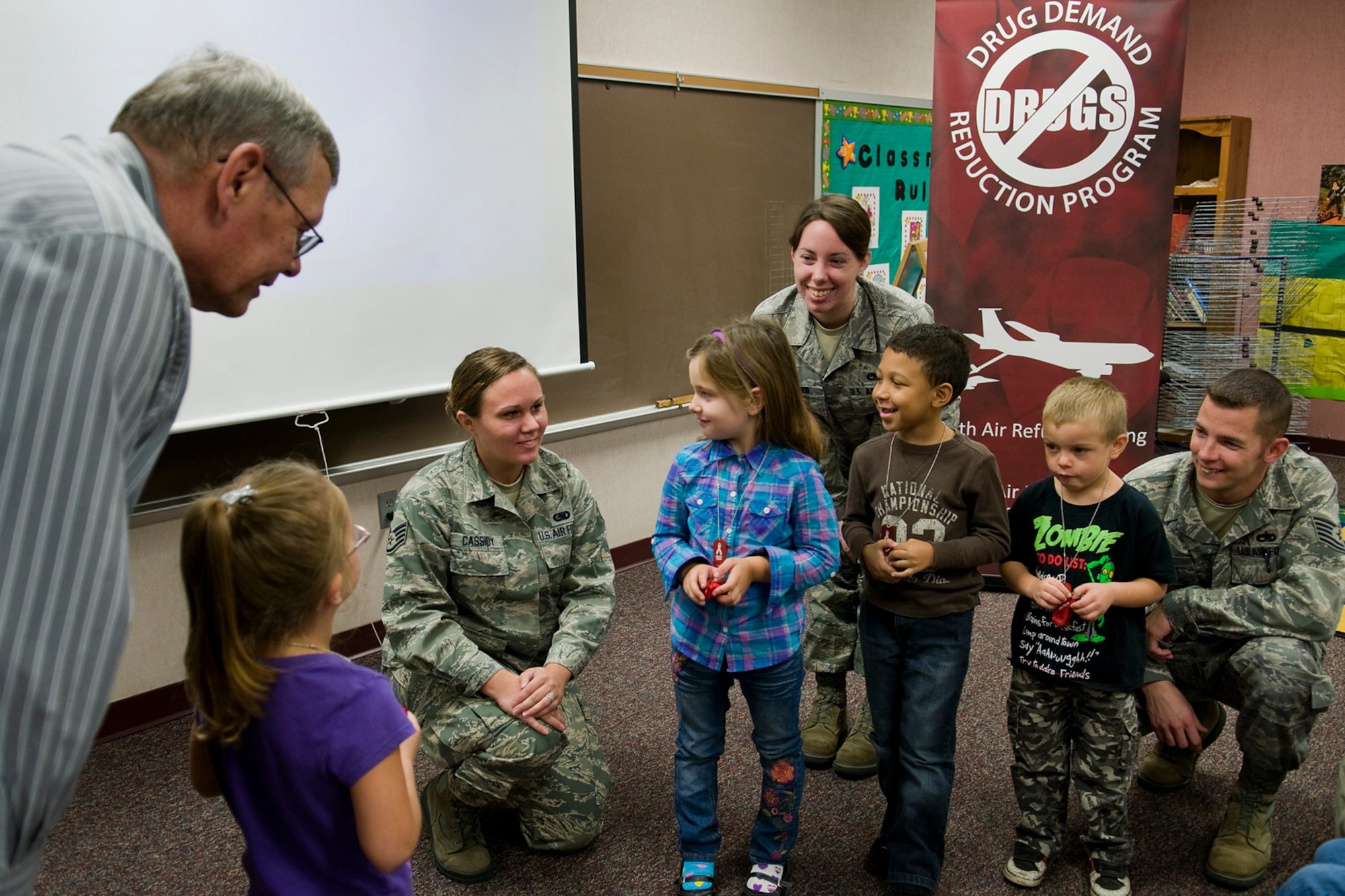 Kindergarten students from Pipe Creek Elementary in Peru, Ind., participate in a peer-pressure role-playing game as personnel from Grissom Air Reserve Base, Ind., instruct them on how to say no to drugs and alcohol Oct. 22. From left are Gary Flook, 434th Air Refueling Wing drug demand specialist; Bailey Holly; Staff Sgt. Lindsey Cassidy, 434th Logistics Readiness Squadron orderly room administrator; Alivia Brown; Senior Airman Alina Palmer, 434th Aircraft Maintenance Squadron KC-135 crew chief; Malachi Bryant; William Navas; and Tech. Sgt. Jordan Winans, 434th Maintenance Operations Flight scheduler. (U.S. Air Force photo/Tech. Sgt. Mark R. W. Orders-Woempner) 
