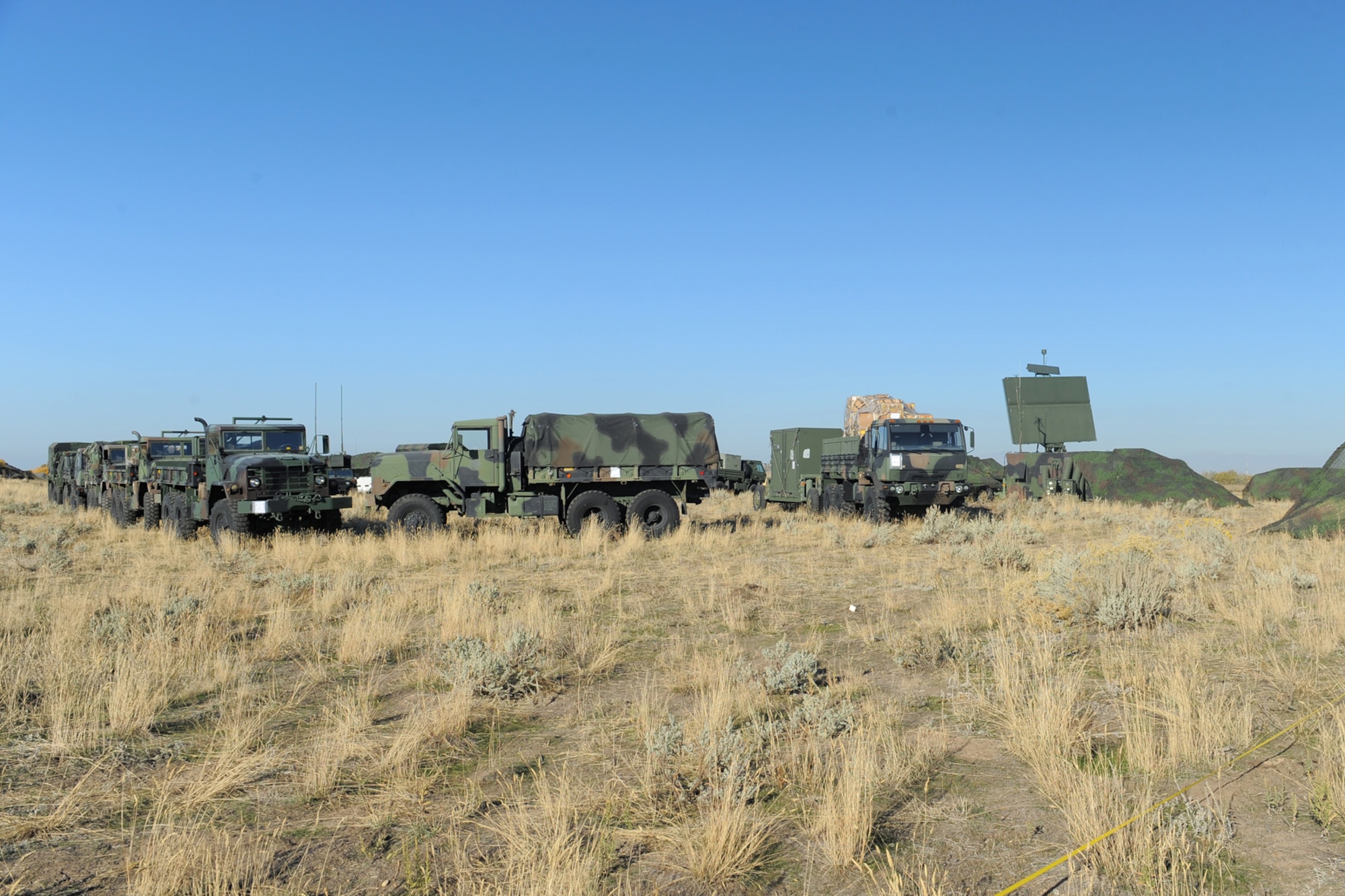 A TPS-75 radar unit and 5-ton trucks are setup to provide a defensive barrier during the 729th Air Control Squadron field training exercise Oct. 24, 2013, at Hill Air Force Base, Utah. (U.S. Air Force photo by Todd Cromar/Released)