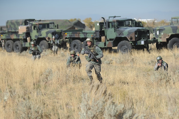 Airman 1st Class Andrew Harmel and fellow Airmen rush to support one of their perimeter defensive fighting positions being attacked during a 729th Air Control Squadron field training exercise Oct. 24, 2013, at Hill Air Force Base, Utah. (U.S. Air Force photo by Todd Cromar/Released)