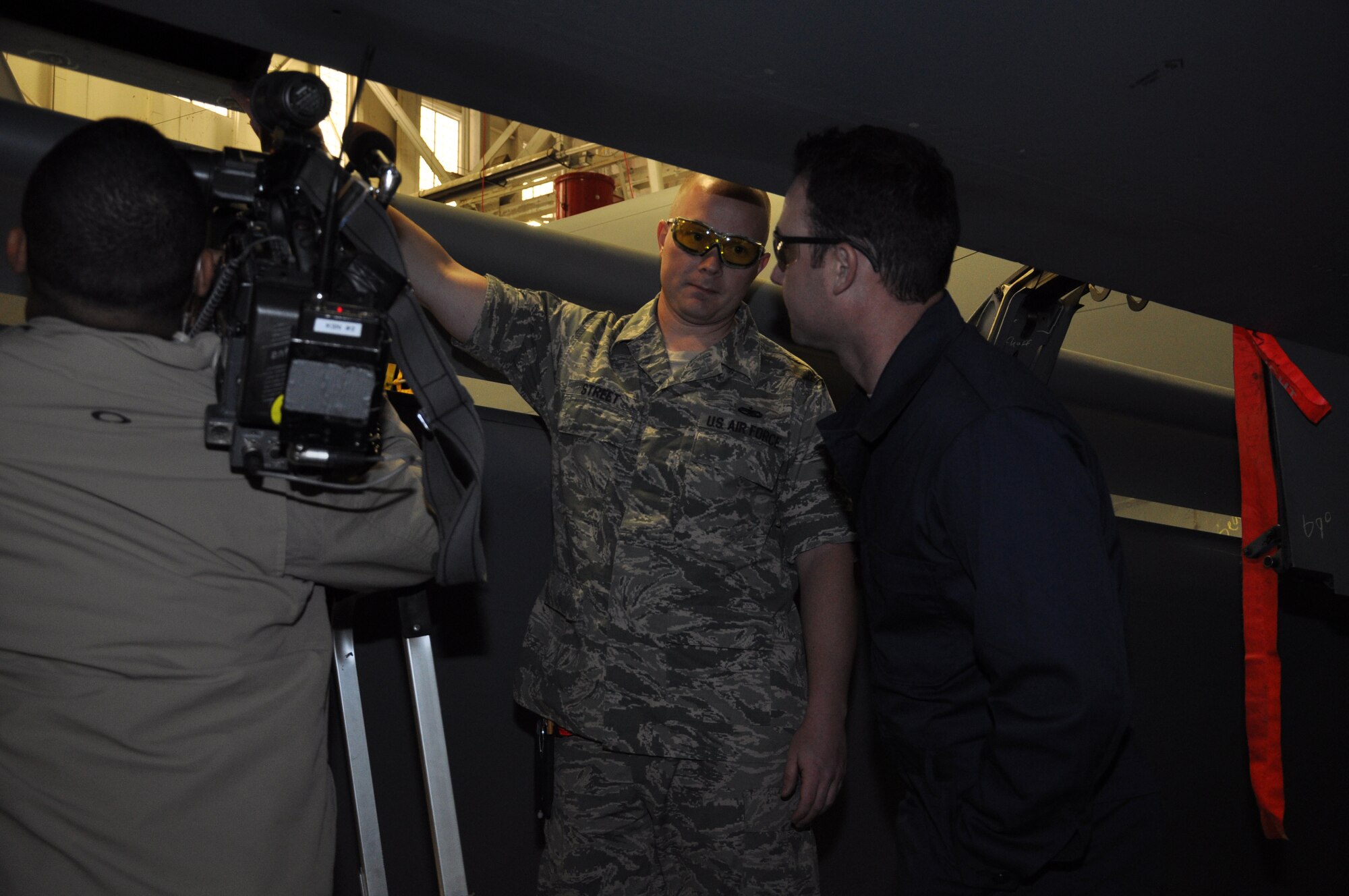 Tech. Sgt. Devin Street, structures NCO from the 931st Maintenance Squadron is interviewed by Mark Davidson, a News Reporter from KSN News, Wichita during part two of Davidson's "Airman For a Day" experience at the periodic inspection dock at McConnell Air Force Base, Kan., Oct. 25. Street was demonstrating how structures Airmen replace rivets on the wing of a KC-135 Stratotanker. Davdison's "Airman For a Day" episode will run in mid-November. (Air Force photo by Master Sgt. Brannen Parrish)