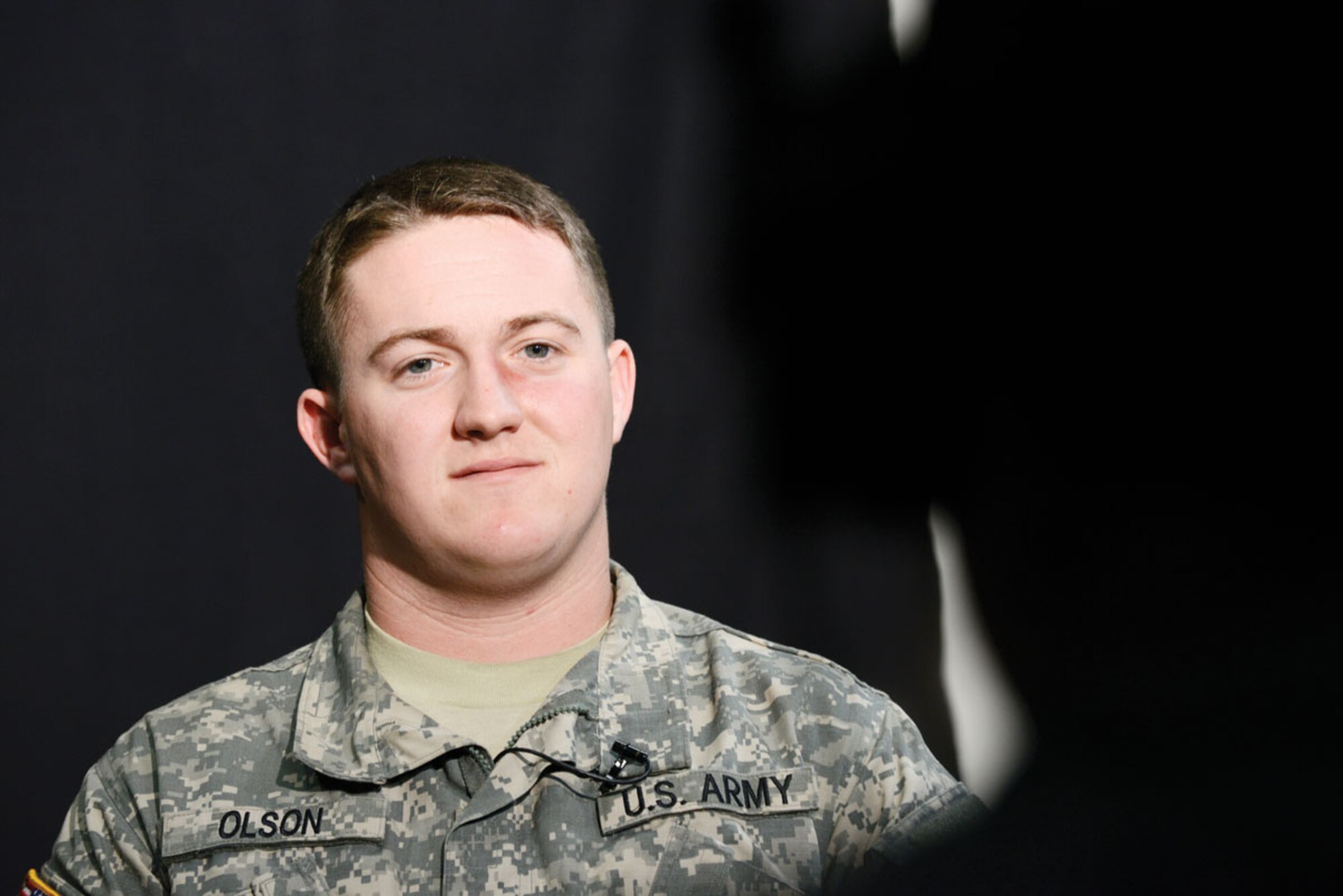 Pfc. Austin Olson, of the 725th Brigade Support Battalion (Airborne), an Army volunteer with the ‘Thanks For Asking’ campaign, responds to an interviewer regarding his experience being moulaged with mock injuries to see responses in his unit and in common areas of JBER. (U.S. Air Force photo/Staff Sgt. Michael Cowley)