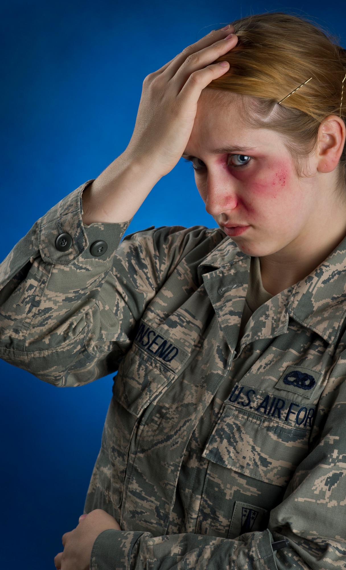 Senior Airman Ashlie Townsend, assigned to 3d Aircraft Maintenance Squadron, a native of Memphis, Mich., poses for a photograph with moulage for the "Thanks For Asking" domestic violence awareness campaign at Joint Base Elmendorf-Richardson, Alaska, Tuesday, Oct. 22, 2013. (U.S. Air Force photo by Justin Connaher/Released)