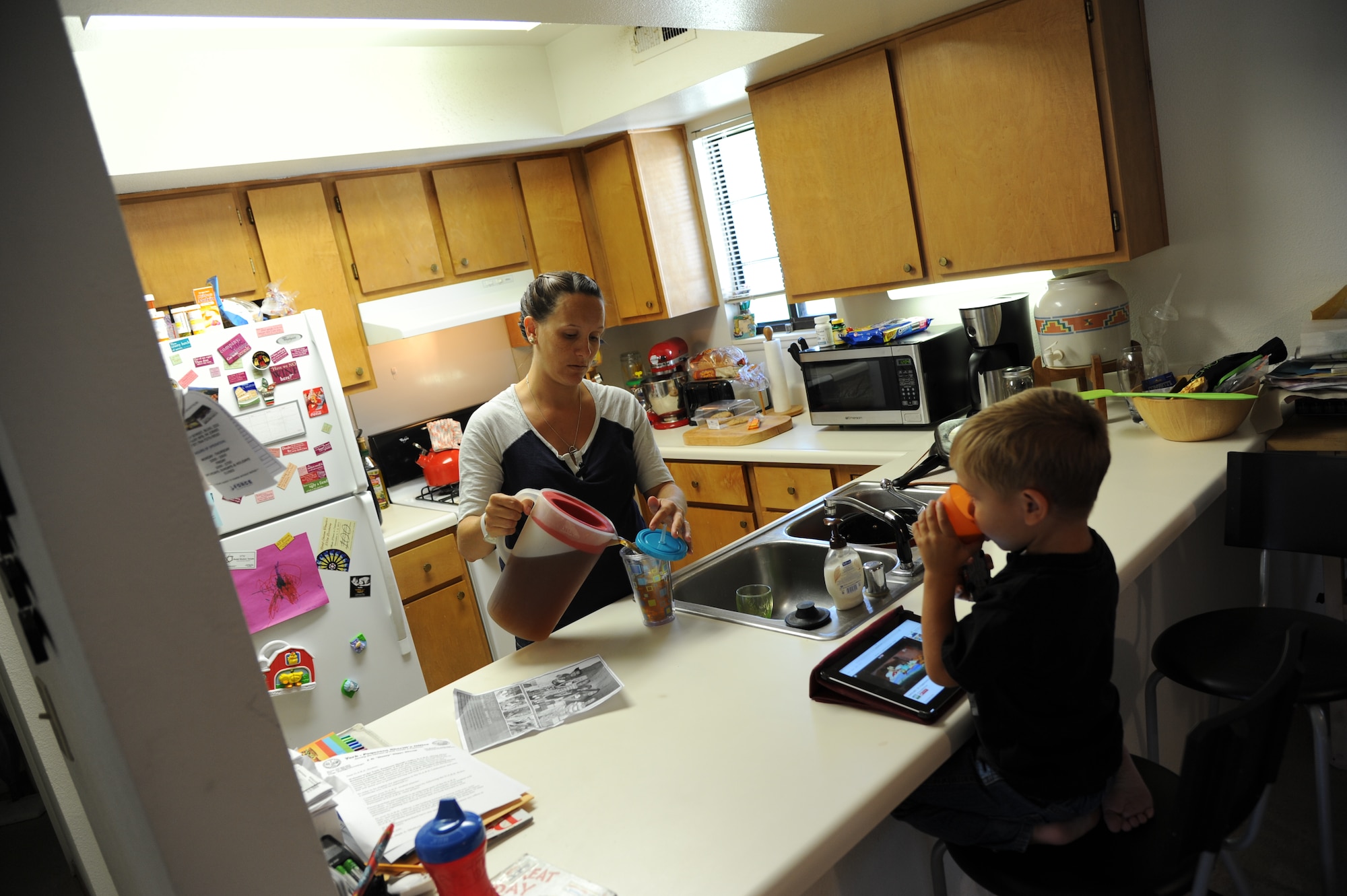 Tanya Lacey is making lunch for her son while her other child is at school and her husband deployed to Japan. (U.S Air Force photo by Staff Sgt. Steve Stanley/Released)