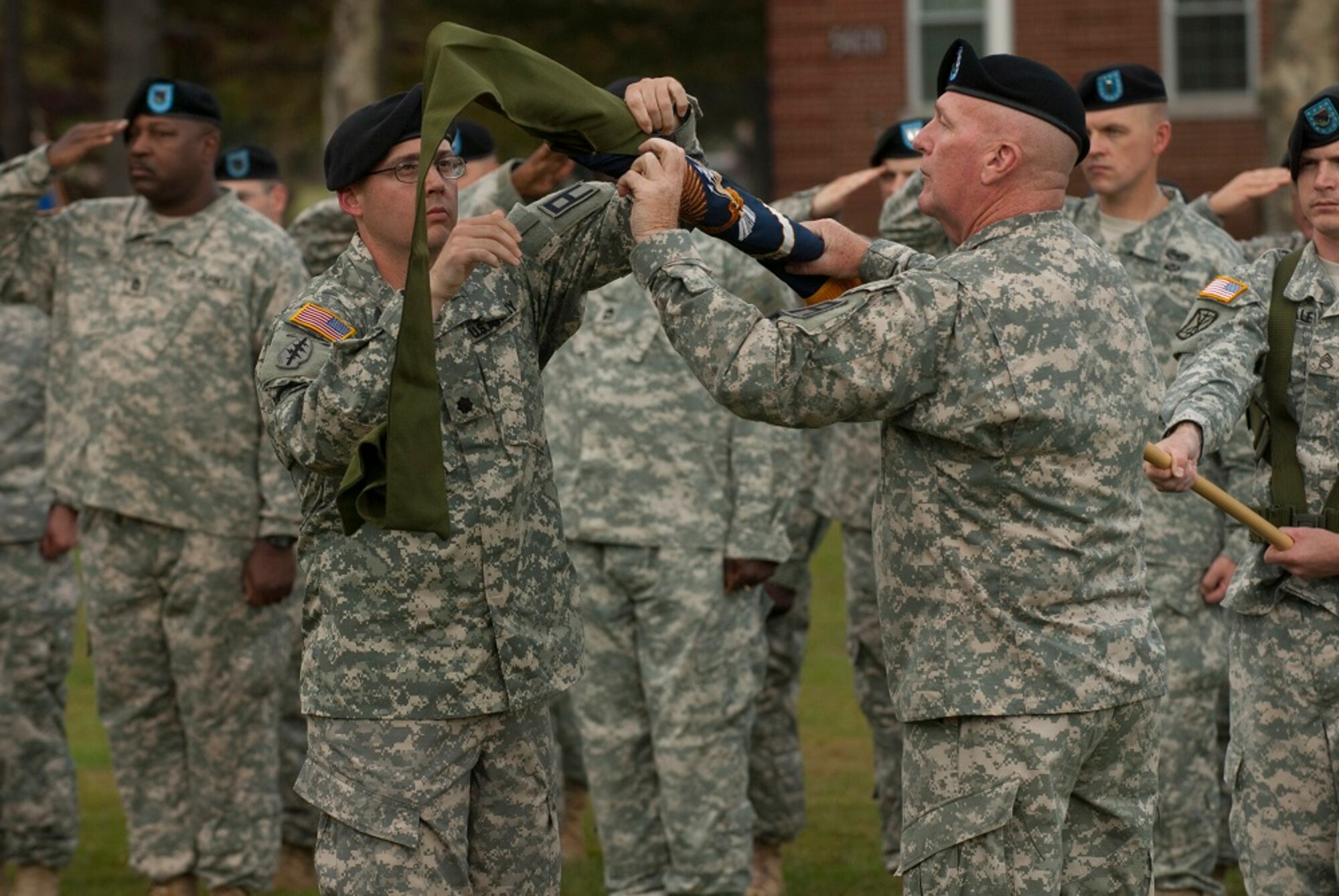 Lt. Col. Michael Magliocco, left, and Command Sgt. Maj. Dale P. Hanavan, right, case the 2nd Battalion, 309th Regiment's battalion colors as soldiers salute during a transfer of authority ceremony Oct. 17, 2013, at Joint Base McGuire-Dix-Lakehurst, N.J. The act signifies the transfer of mission from the 2-309th Reg. to the incoming 2nd Battalion, 312th Regiment, both U.S. Army Reserve units assigned to 174th Infantry Brigade, First Army Division East. (U.S. Army photo by Sgt. 1st Class Stan Maszczak/Released)