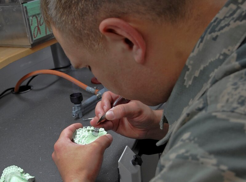 Staff Sgt. Christian Maes, 2nd Dental Squadron laboratory technician, carves anatomy into a tooth mold in the dental lab on Barksdale Air Force Base, La., Oct. 22, 2013. The mold will be used to create a realistic artificial crown for the patient. (U.S. Air Force photo/Senior Airman Kristin High)