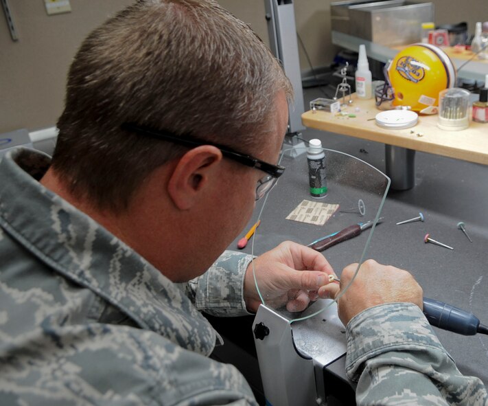 Master Sgt. Denny Shaffer, 2nd Dental Squadron laboratory technician, shapes a porcelain implant in the dental lab on Barksdale Air Force Base, La., Oct. 22, 2013. Screws are put into implants to help hold their place in the jaw. (U.S. Air Force photo/Senior Airman Kristin High)